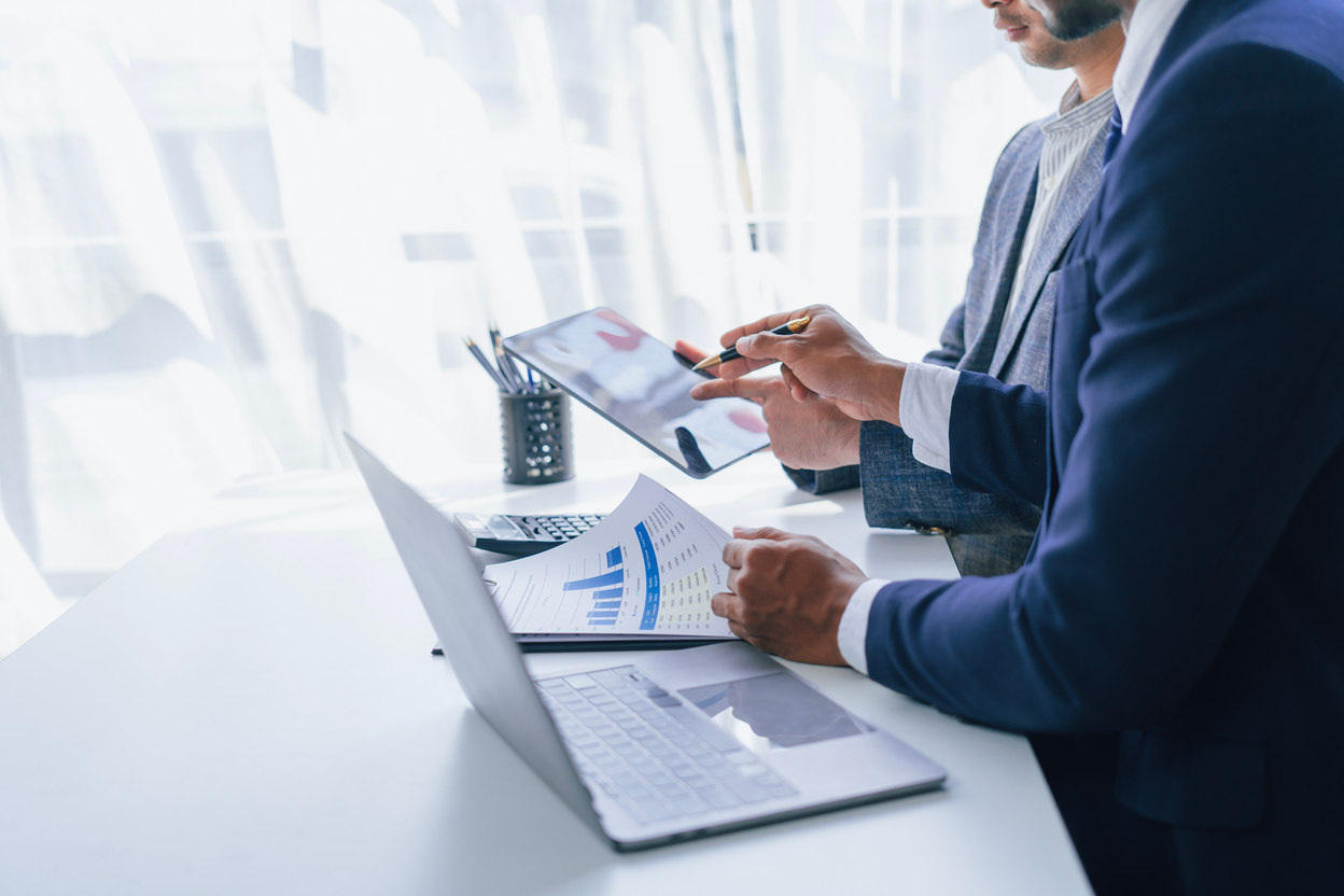 Business professional working with tablet and documents